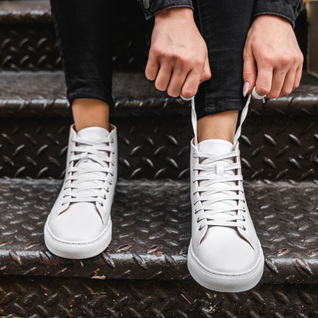 Premium Photo | Closeup of female legs in jeans and casual white sneakers  women's comfortable casual shoes white leather women's sneakers